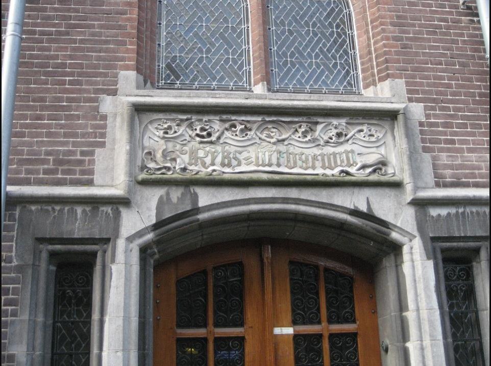 Carved stone entrance lettering reading Rijks-Herbarium above a doorway on Nonnensteeg, Leiden